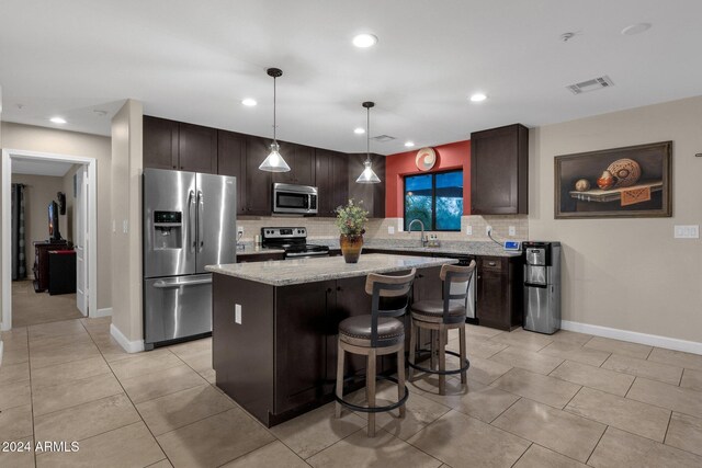15019 N Mayflower Dr, Fountain Hills, AZ 85268 - kitchen featuring stainless steel appliances, dark brown cabinets, a kitchen island, tasteful backsplash, and recessed lighting