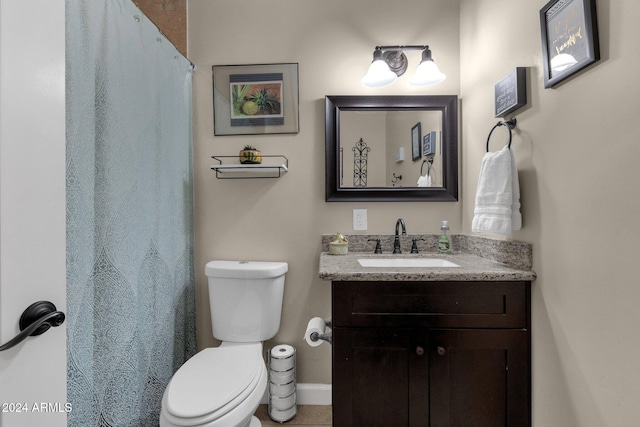 bathroom with vanity, toilet, and walk in shower