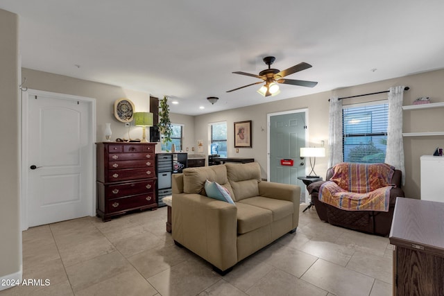 living room featuring light tile patterned floors and ceiling fan