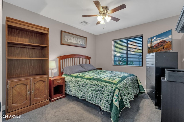 bedroom with ceiling fan and light colored carpet