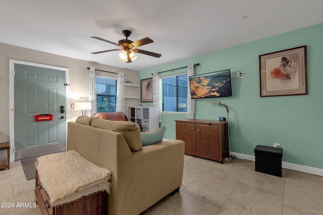 living room with ceiling fan and light tile patterned floors