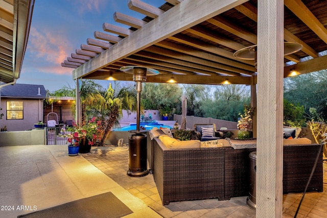 patio terrace at dusk featuring an outdoor hangout area and a fenced in pool