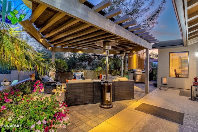 patio terrace at dusk with a pergola and an outdoor hangout area