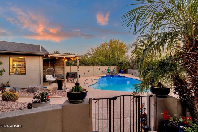 15019 N Mayflower Dr, Fountain Hills, AZ 85268 - pool at dusk with a fenced backyard, a patio, and a gate