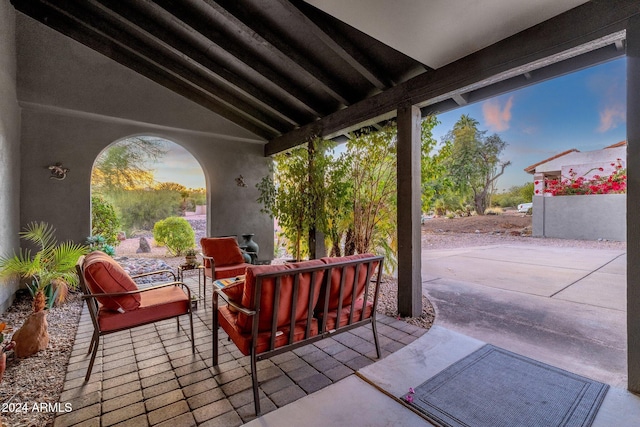 patio terrace at dusk featuring outdoor lounge area