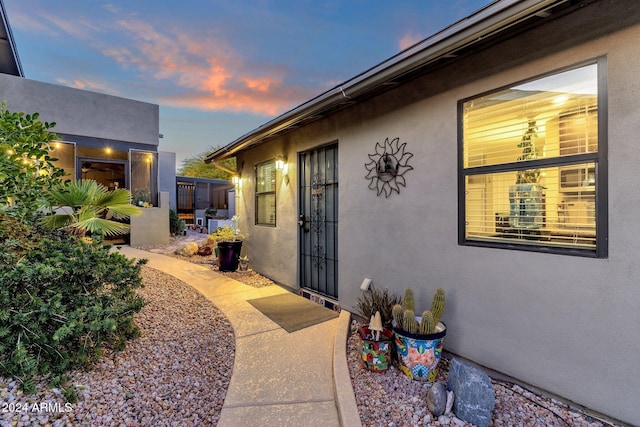 15019 N Mayflower Dr, Fountain Hills, AZ 85268 - exterior entry at dusk with stucco siding