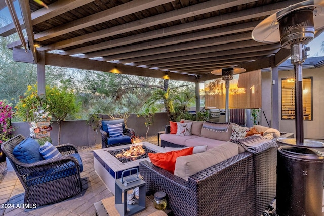 view of patio with an outdoor living space with a fire pit