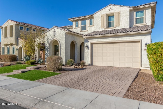 mediterranean / spanish-style home with a garage