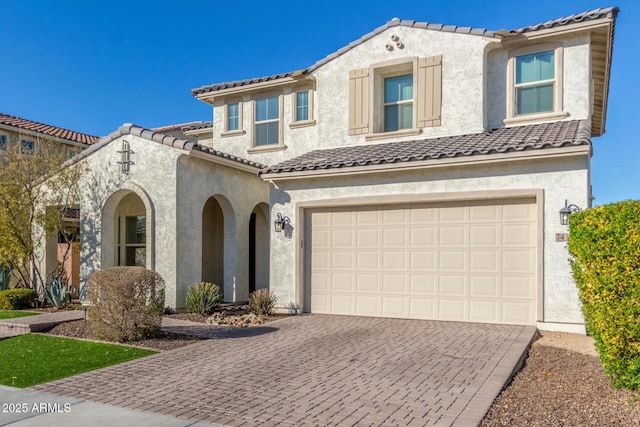 mediterranean / spanish-style house with a garage