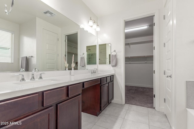 bathroom featuring tile patterned flooring and vanity