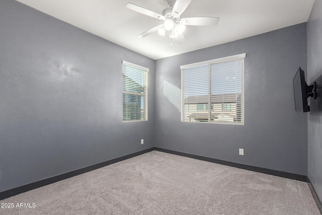 carpeted empty room featuring ceiling fan