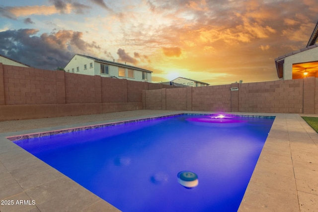 view of pool at dusk