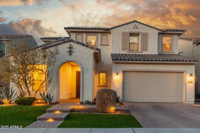 mediterranean / spanish home featuring a garage