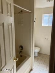 bathroom featuring toilet, tile patterned floors, and tub / shower combination