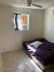 unfurnished bedroom featuring ceiling fan, cooling unit, and light tile patterned floors