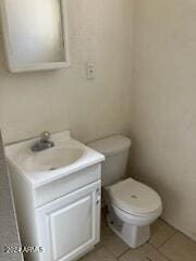 bathroom with vanity, toilet, and tile patterned flooring