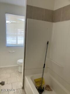 bathroom with toilet, tile patterned floors, and separate shower and tub