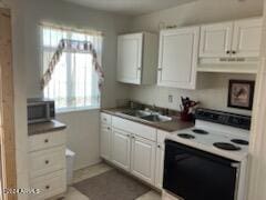 kitchen with sink, white range with electric cooktop, and white cabinets