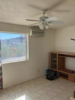 unfurnished room with a wall mounted AC and ceiling fan