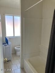 bathroom featuring toilet, tile patterned floors, and independent shower and bath