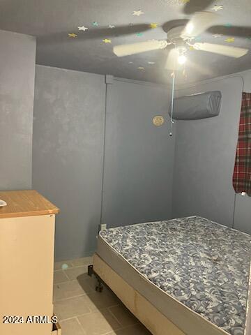 tiled bedroom with ceiling fan