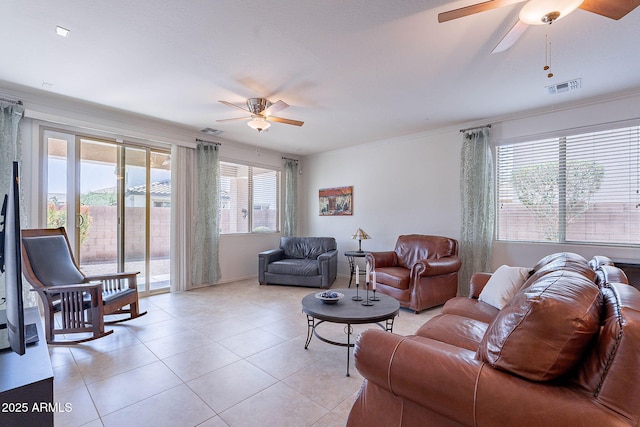 living area featuring light tile patterned floors, ceiling fan, and visible vents