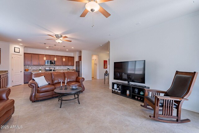 living room featuring recessed lighting, ornamental molding, a ceiling fan, and light tile patterned floors