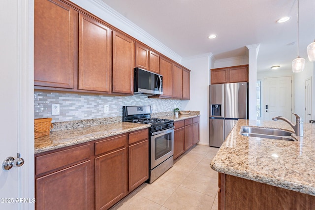 kitchen with brown cabinets, a sink, decorative backsplash, light stone counters, and appliances with stainless steel finishes