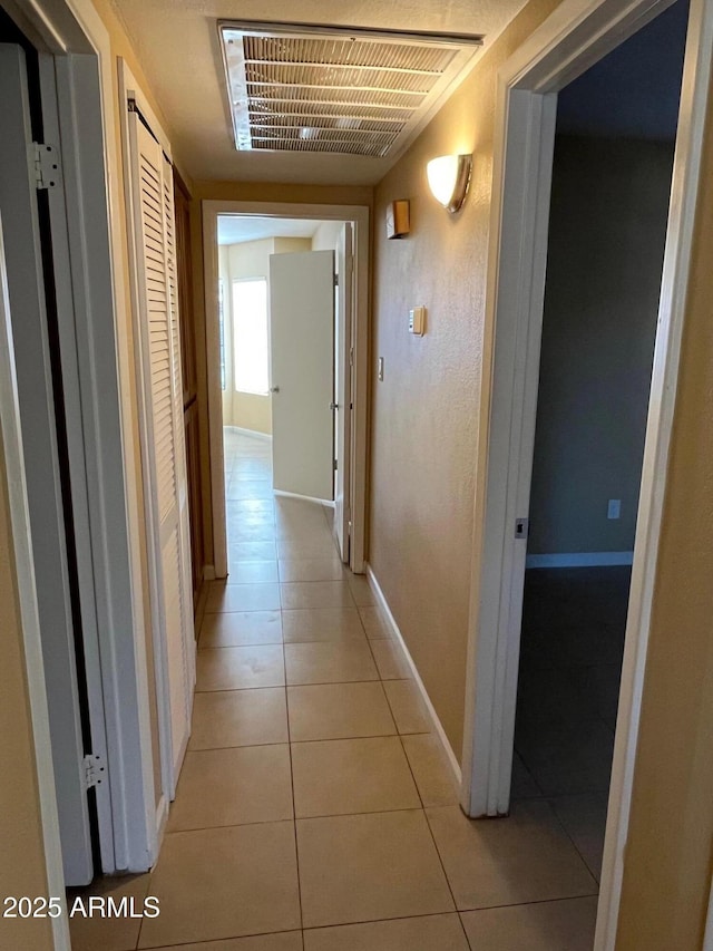 corridor featuring light tile patterned floors