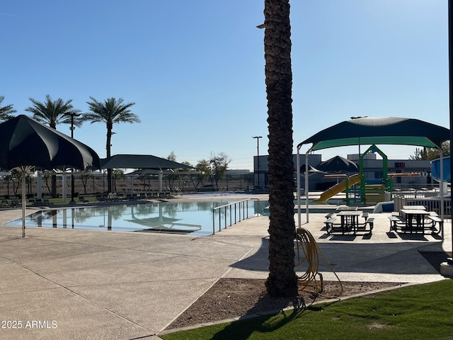 view of swimming pool featuring a playground