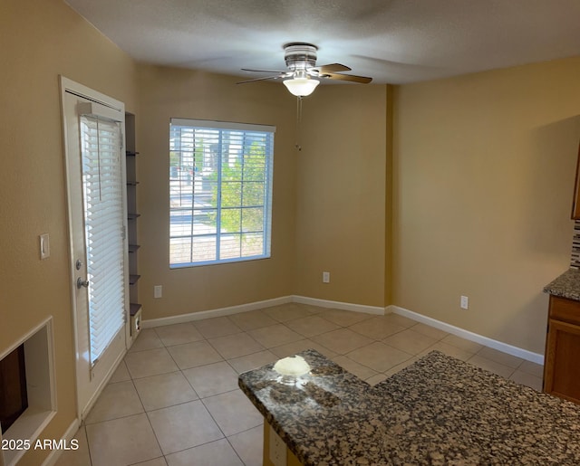 interior space featuring ceiling fan and light tile patterned floors