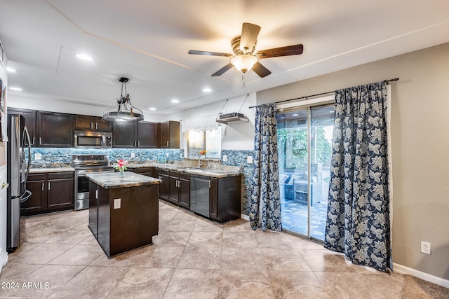 kitchen featuring stainless steel appliances, sink, backsplash, a center island, and ceiling fan