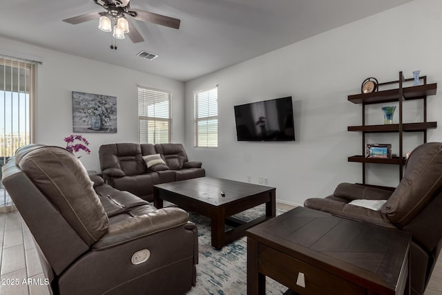 living room featuring ceiling fan and light hardwood / wood-style floors