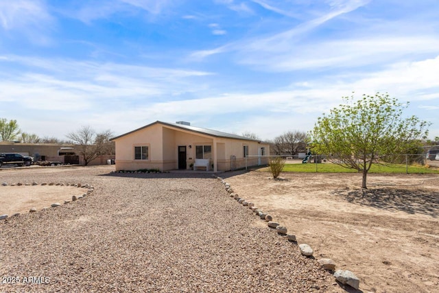 rear view of property featuring fence