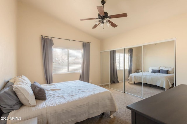 bedroom featuring carpet floors, lofted ceiling, ceiling fan, and a closet