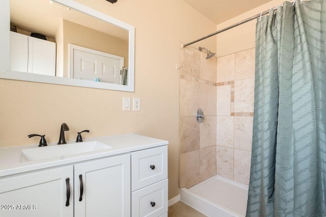 bathroom with a stall shower and vanity