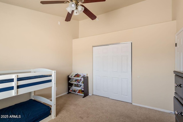 carpeted bedroom featuring baseboards and ceiling fan