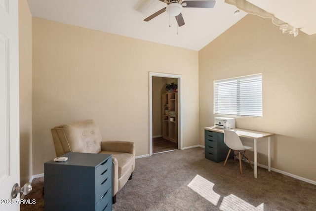 carpeted office featuring baseboards, lofted ceiling, and a ceiling fan
