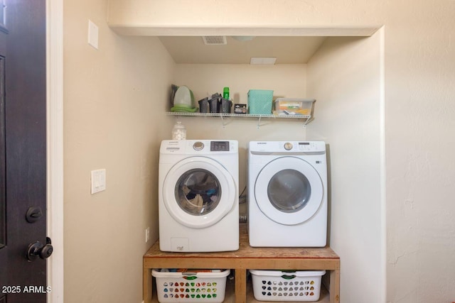 laundry room featuring washing machine and dryer and laundry area