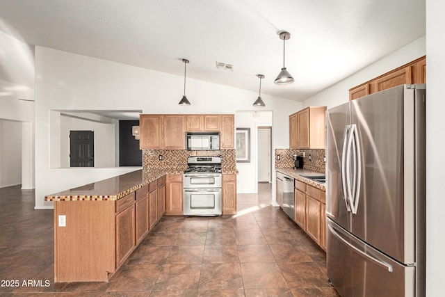 kitchen featuring a peninsula, visible vents, vaulted ceiling, appliances with stainless steel finishes, and backsplash