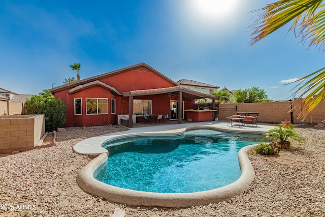 view of swimming pool featuring a patio area, a fenced backyard, and a fenced in pool