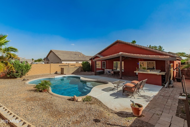 view of pool featuring a patio area, a fenced backyard, outdoor dry bar, and a fenced in pool