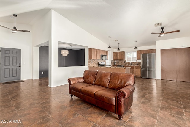 living area featuring a ceiling fan, visible vents, and high vaulted ceiling