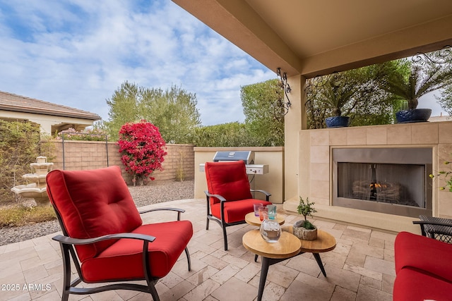 view of patio / terrace featuring an outdoor fireplace