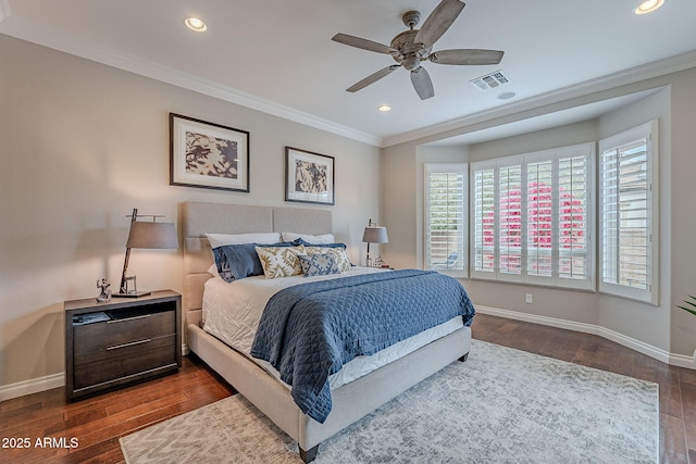 bedroom with dark wood-type flooring, ornamental molding, and ceiling fan