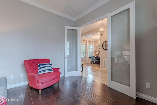 sitting room featuring an inviting chandelier, ornamental molding, hardwood / wood-style floors, and french doors