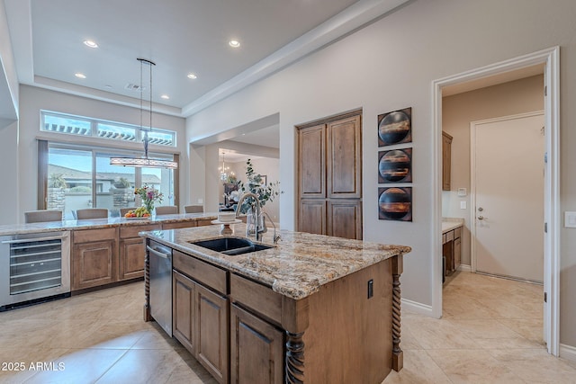 kitchen with light tile patterned flooring, decorative light fixtures, an island with sink, sink, and wine cooler