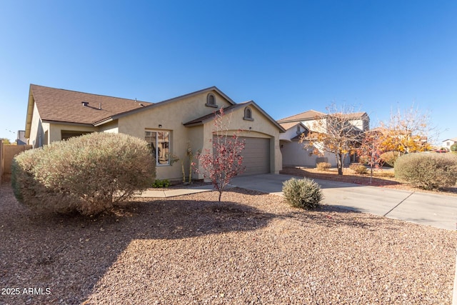 ranch-style house with a garage, concrete driveway, and stucco siding