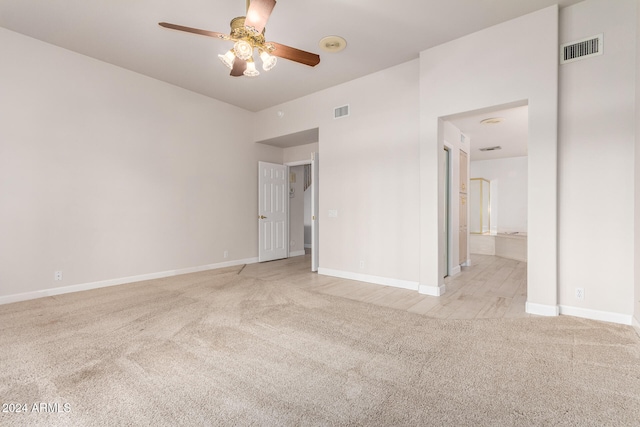 empty room with ceiling fan and light colored carpet