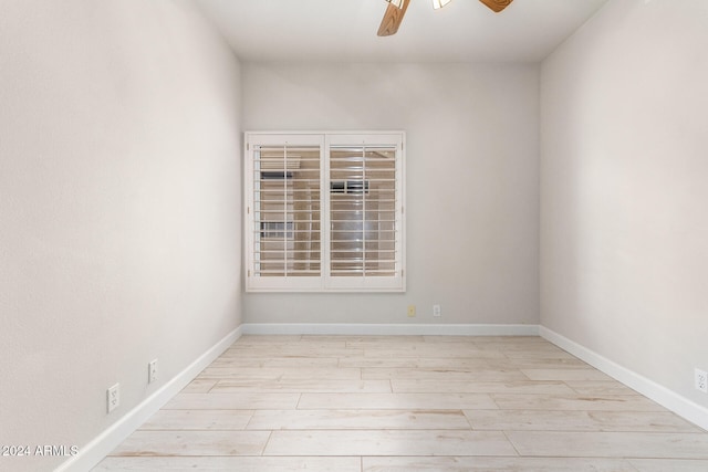 empty room featuring ceiling fan and light hardwood / wood-style flooring